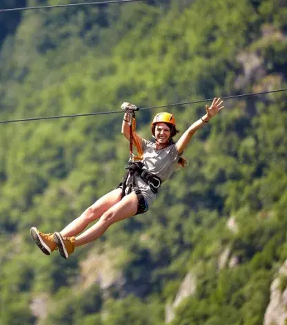 Guest ziplining above the treetops